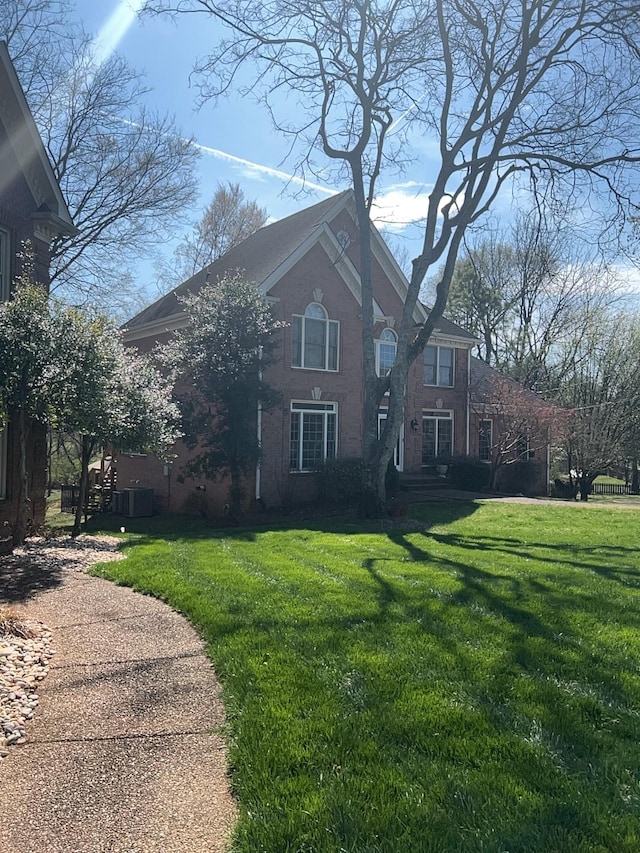 view of side of home with a lawn