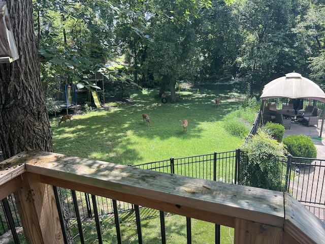 view of yard featuring a gazebo and a trampoline