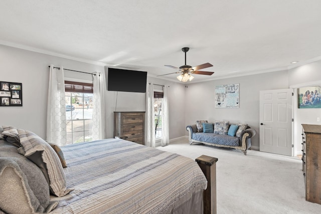 carpeted bedroom featuring ornamental molding and ceiling fan