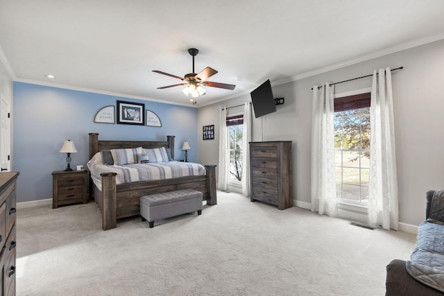 carpeted bedroom featuring ceiling fan, crown molding, and multiple windows