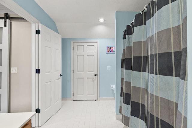 bathroom with lofted ceiling and vanity