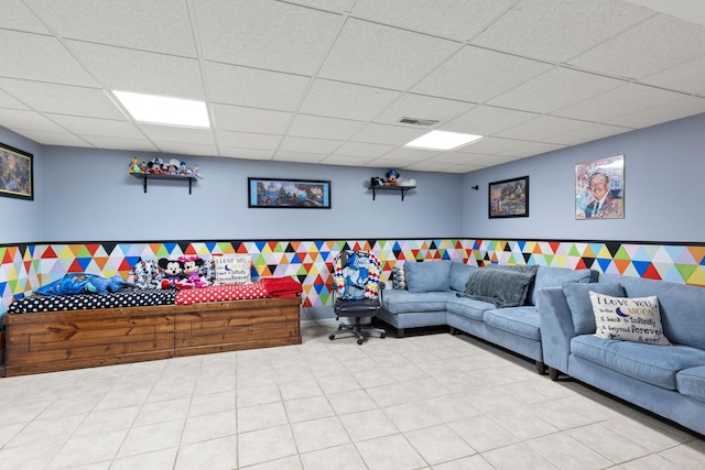 living room with a drop ceiling