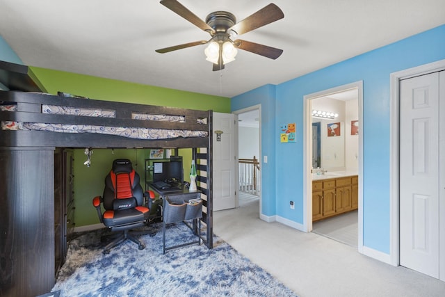 bedroom with connected bathroom, ceiling fan, and light colored carpet