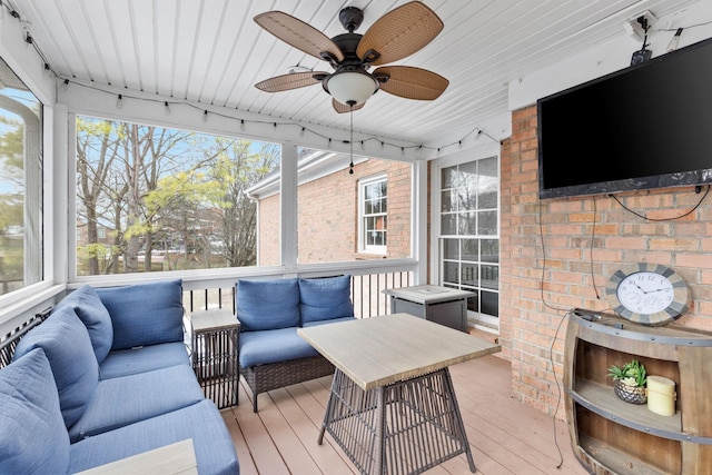 wooden terrace featuring ceiling fan and outdoor lounge area