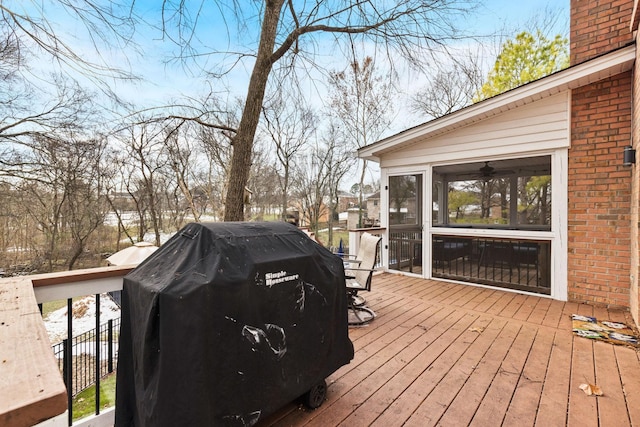 deck with a sunroom and a grill