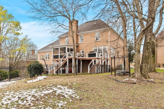 rear view of property featuring a sunroom