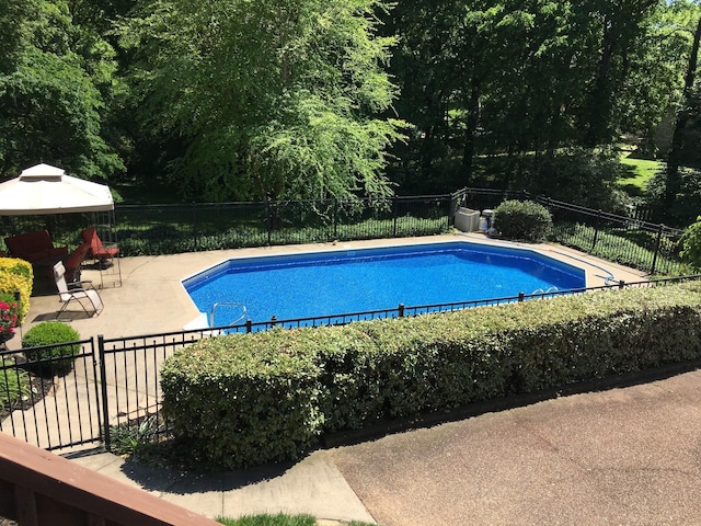 view of swimming pool featuring a gazebo and a patio area