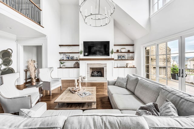 living room featuring hardwood / wood-style floors, a high ceiling, and an inviting chandelier