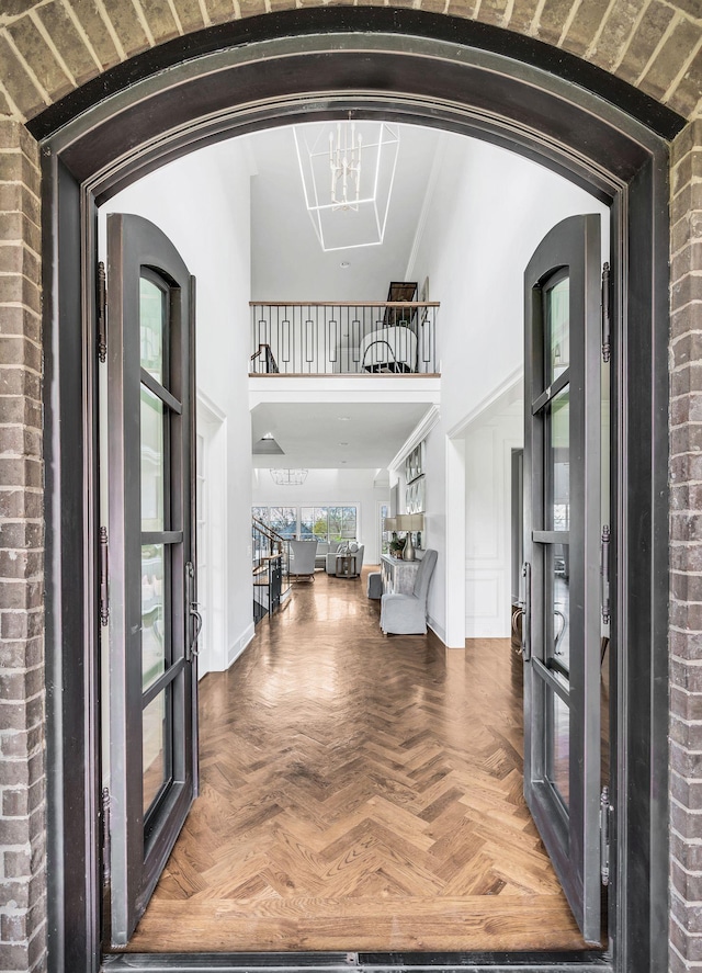 entrance foyer with a notable chandelier and parquet floors