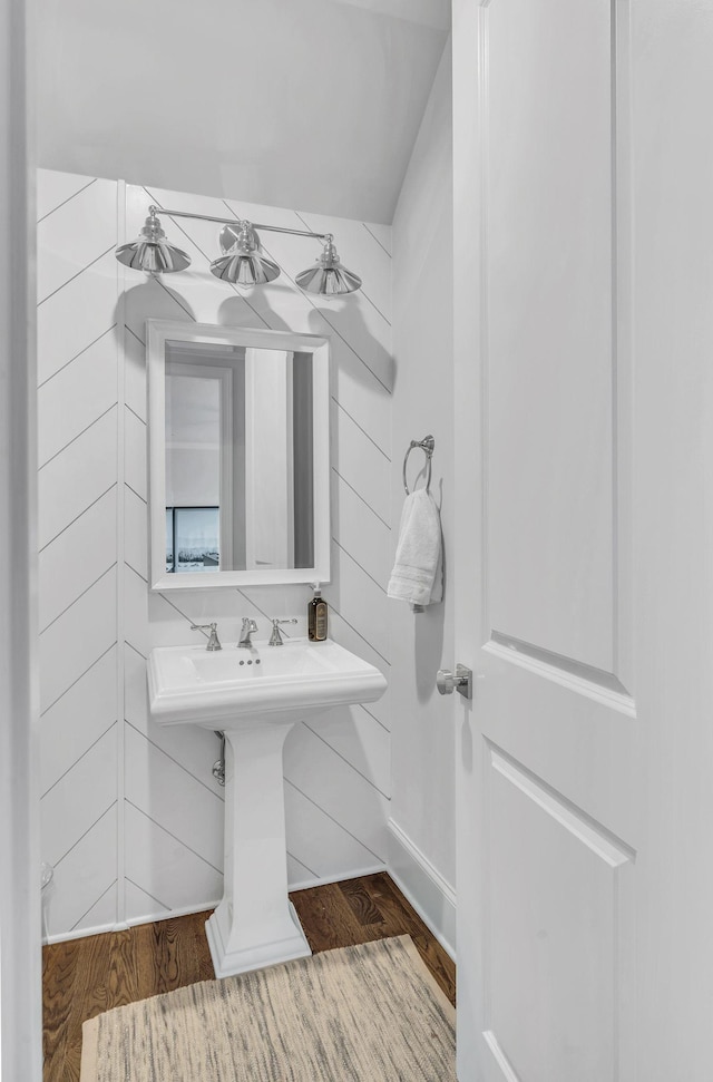 bathroom with wood walls and hardwood / wood-style floors