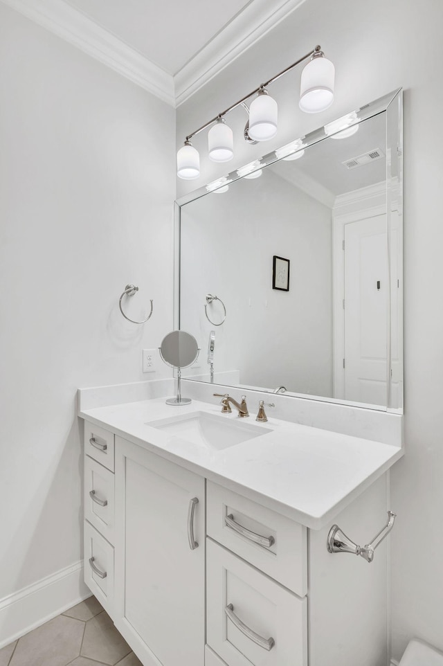 bathroom featuring crown molding, tile patterned flooring, and vanity