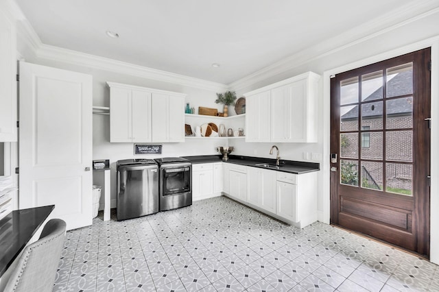 kitchen featuring stainless steel electric range oven, sink, white cabinets, and ornamental molding