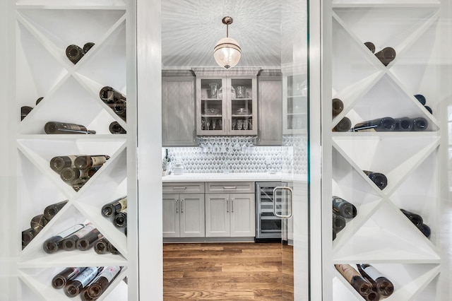 wine cellar featuring beverage cooler and wood-type flooring