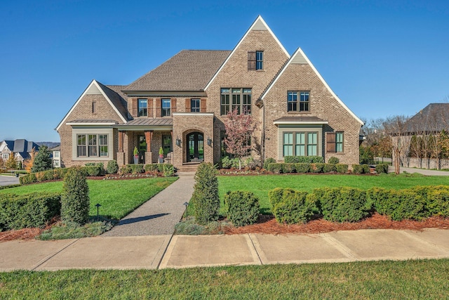 english style home with a front lawn