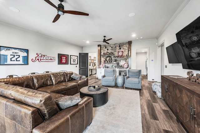 living room with dark hardwood / wood-style flooring, ceiling fan, and crown molding