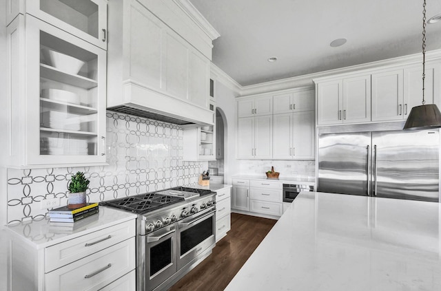 kitchen with white cabinets, decorative light fixtures, and appliances with stainless steel finishes