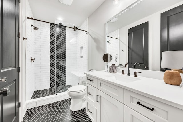 bathroom with vanity, toilet, and a shower with shower door