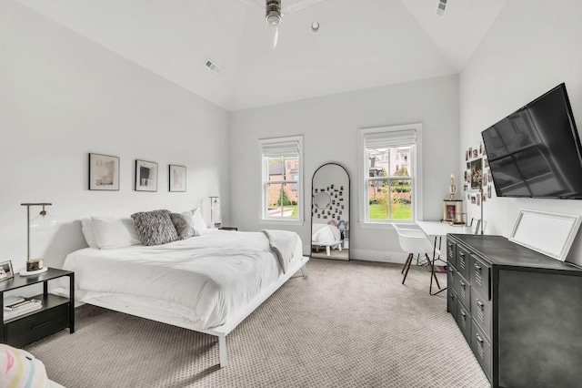 carpeted bedroom with ceiling fan and vaulted ceiling