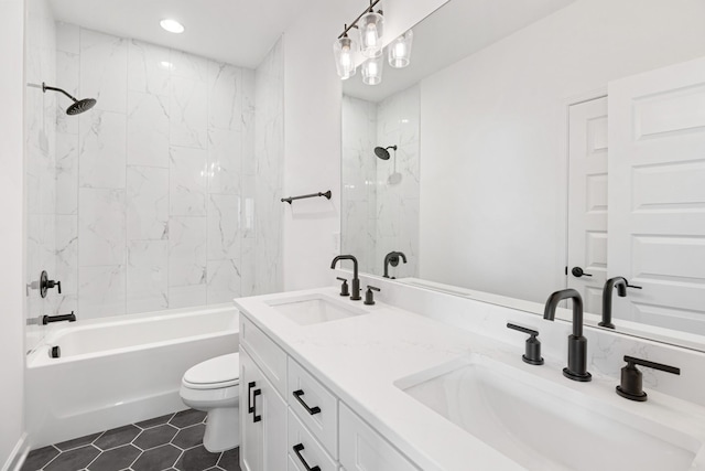 full bathroom featuring vanity, tiled shower / bath combo, and toilet