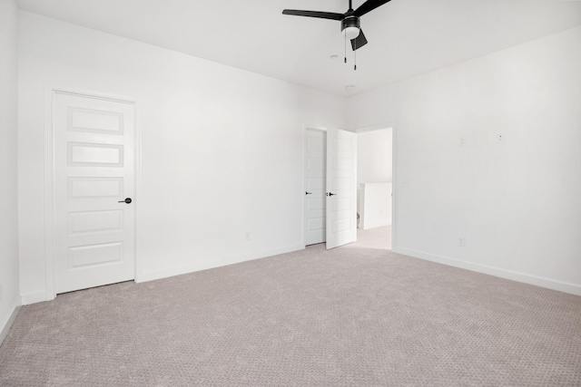 unfurnished room featuring ceiling fan and light carpet