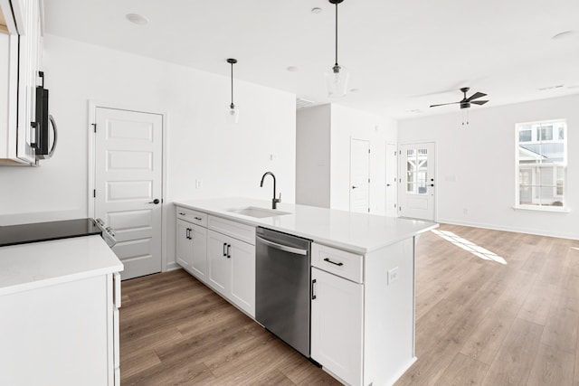 kitchen featuring stainless steel dishwasher, ceiling fan, sink, decorative light fixtures, and white cabinets