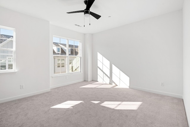 unfurnished room featuring ceiling fan and light carpet