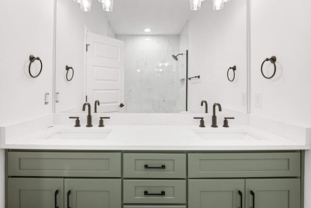 bathroom featuring vanity and tiled shower