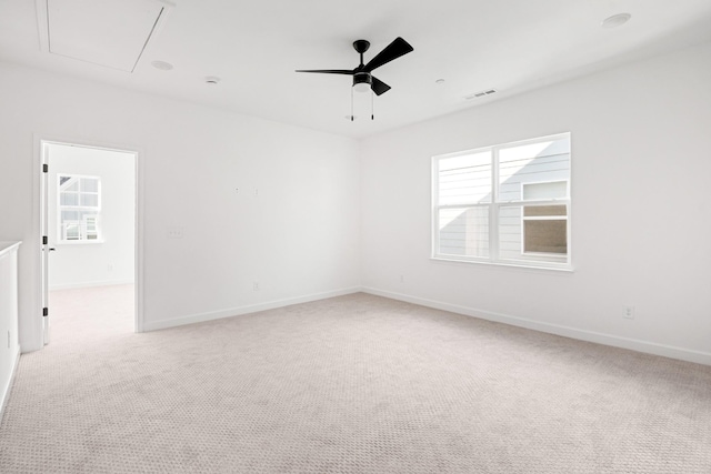 carpeted spare room with ceiling fan and a wealth of natural light