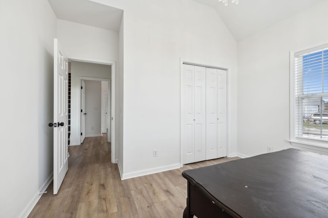 unfurnished office featuring lofted ceiling and light hardwood / wood-style flooring