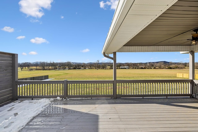 wooden deck featuring a rural view and a lawn