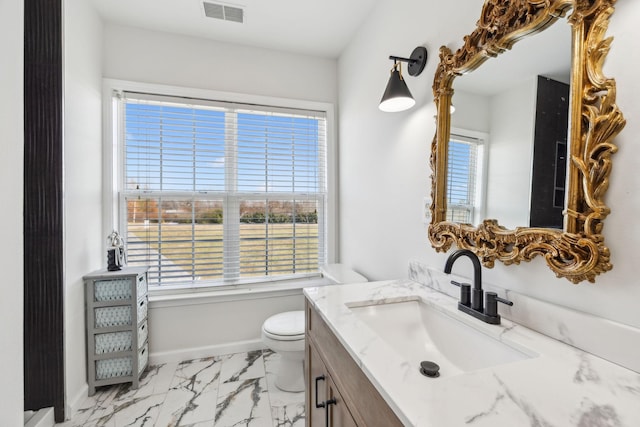 bathroom featuring toilet and vanity