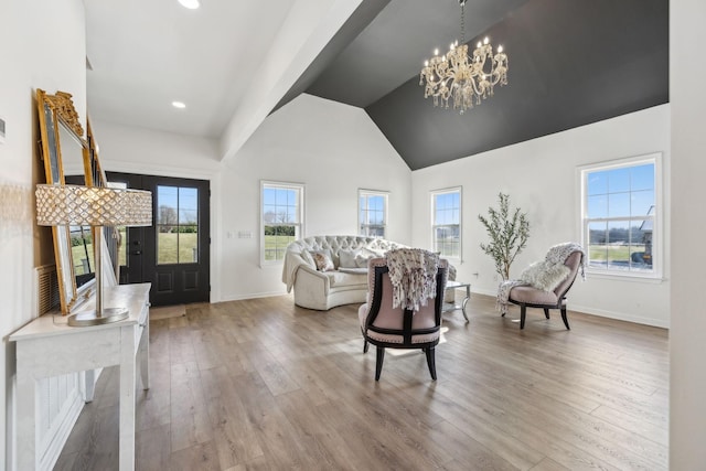 living room featuring an inviting chandelier, a wealth of natural light, and wood-type flooring