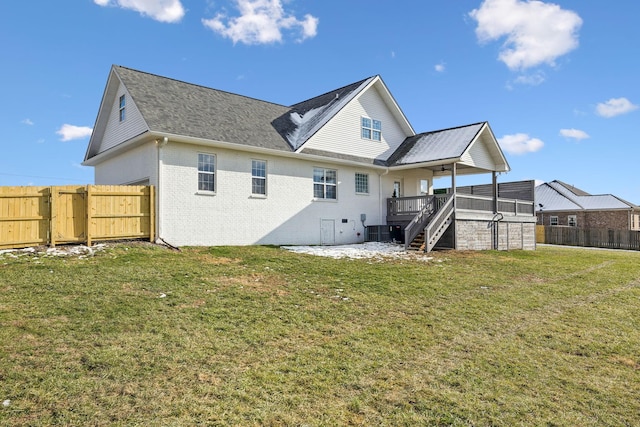 back of house featuring a wooden deck, central air condition unit, and a lawn