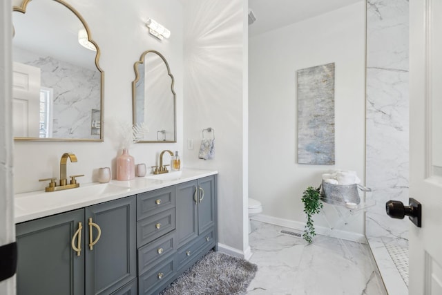 bathroom featuring toilet and vanity