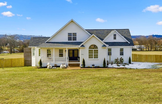 exterior space featuring covered porch and a front lawn