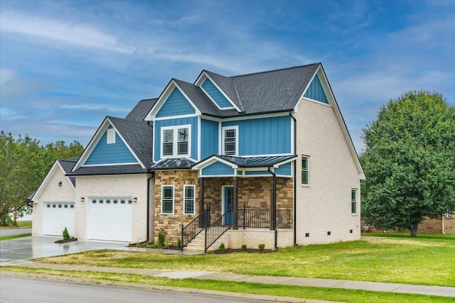 craftsman house with a front yard and a garage