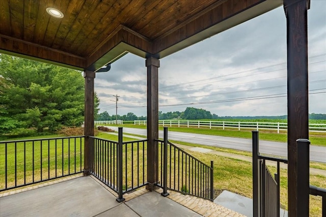 view of patio / terrace with a rural view and covered porch