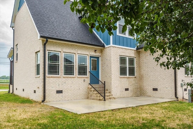 back of property with a patio and a lawn