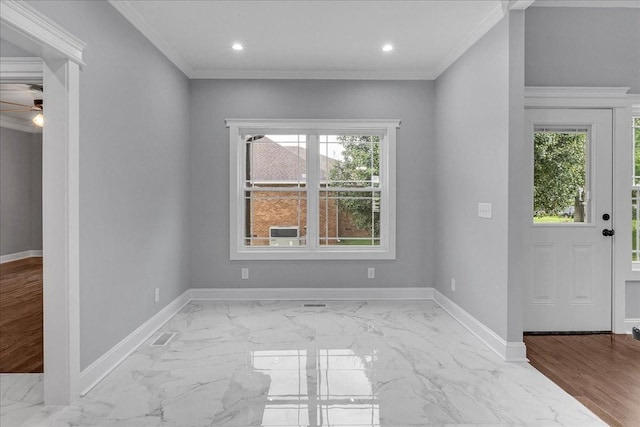 foyer entrance with crown molding and ceiling fan