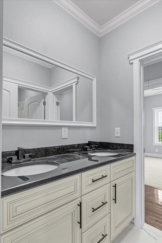 bathroom featuring crown molding and vanity