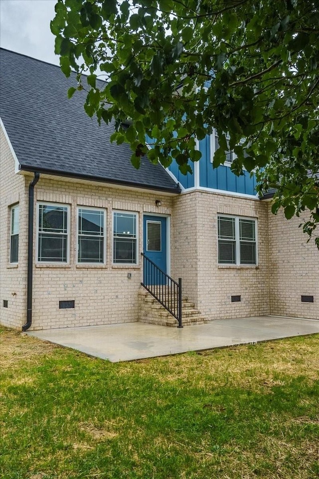 back of house with a yard and a patio area