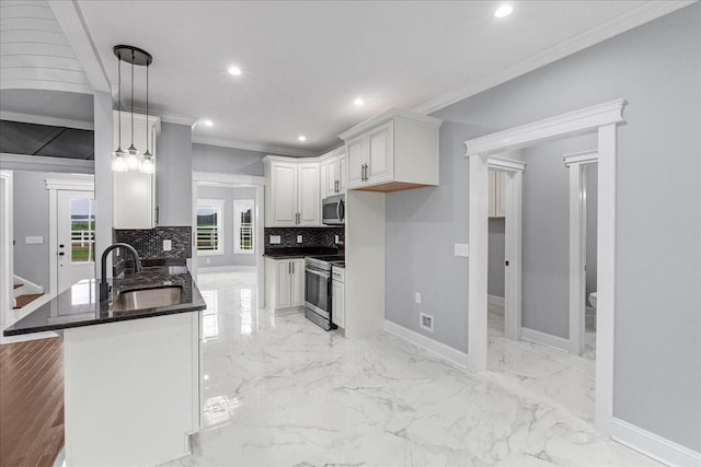 kitchen featuring stainless steel appliances, crown molding, sink, pendant lighting, and white cabinetry