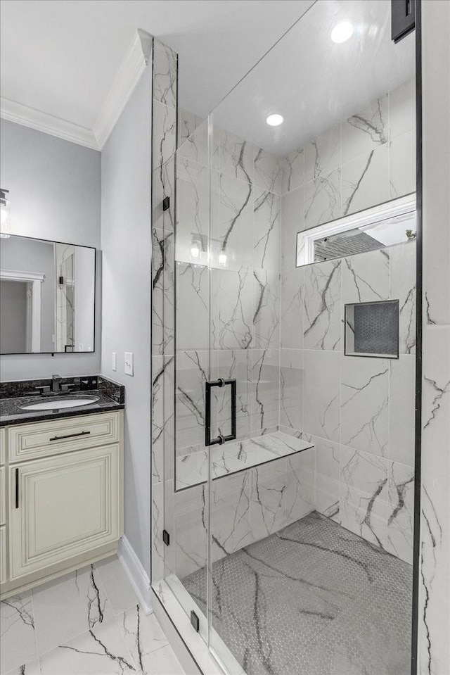 bathroom with vanity, a shower with shower door, and ornamental molding