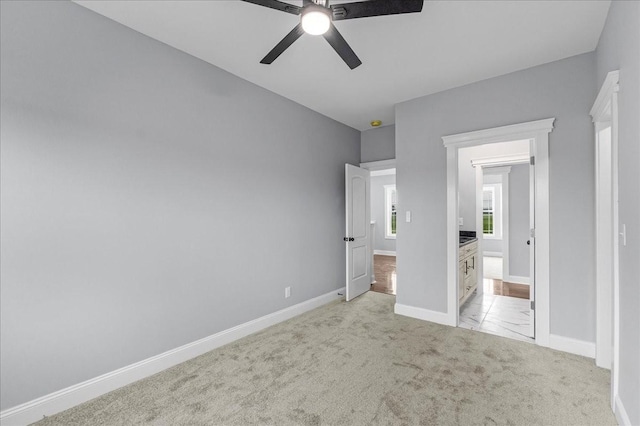 unfurnished bedroom featuring ceiling fan and light colored carpet