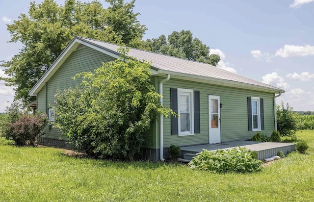 view of side of property with a yard