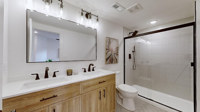 bathroom featuring vanity, toilet, and walk in shower