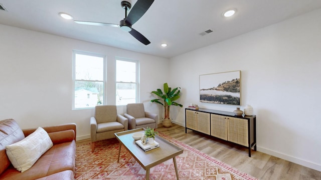 living room featuring hardwood / wood-style floors and ceiling fan