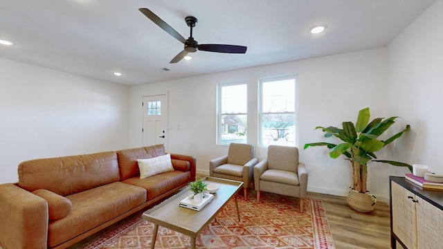 living room with ceiling fan and light wood-type flooring