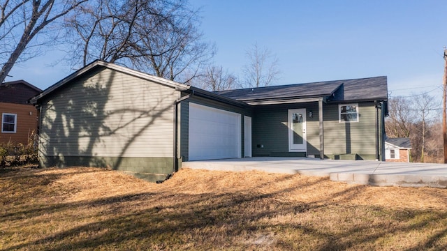 single story home featuring a front yard and a garage