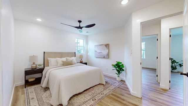 bedroom with ceiling fan and light wood-type flooring